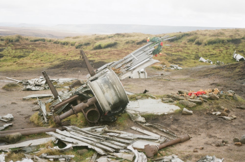 a pile of junk sitting on top of a grass covered field