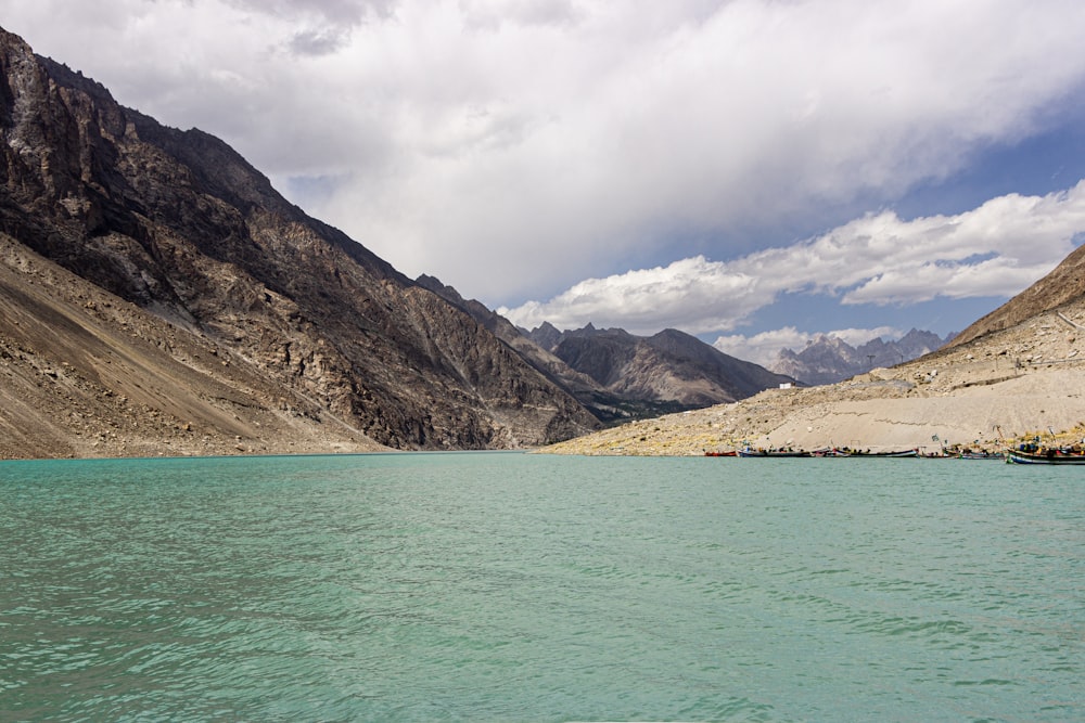 a body of water with mountains in the background