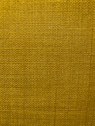 A close-up view of a textured fabric surface with a tight and even weave. The fabric appears to be made of thick threads, tightly interwoven in a grid pattern.