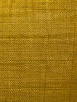 A close-up view of a textured fabric surface with a tight and even weave. The fabric appears to be made of thick threads, tightly interwoven in a grid pattern.
