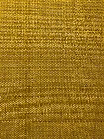 A close-up view of a textured fabric surface with a tight and even weave. The fabric appears to be made of thick threads, tightly interwoven in a grid pattern.