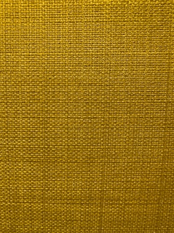A close-up view of a textured fabric surface with a tight and even weave. The fabric appears to be made of thick threads, tightly interwoven in a grid pattern.