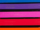 Multiple horizontal layers of vibrant colors stacked vertically, including blue, purple, pink, red, and orange.