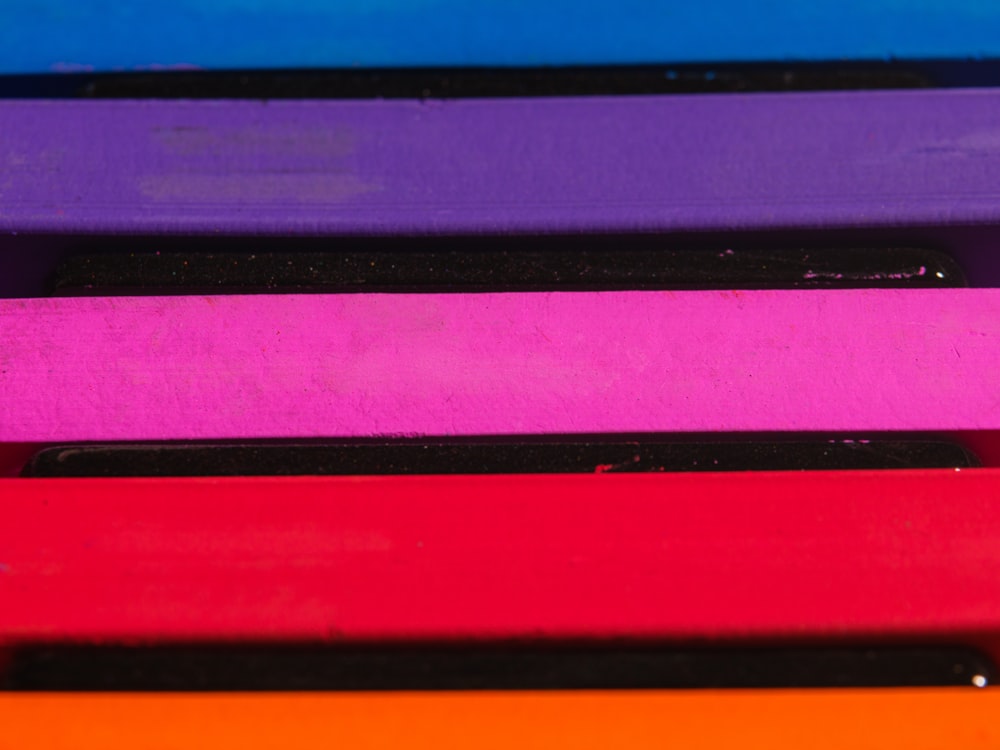 a close up of a stack of different colored papers