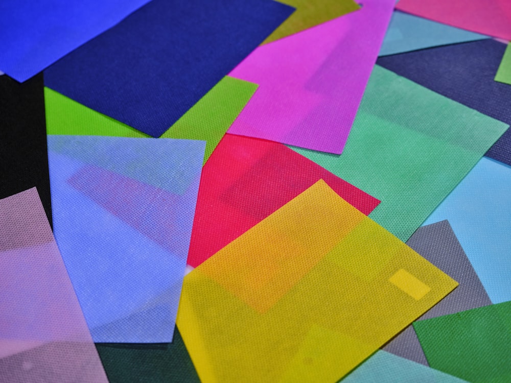 a pile of multicolored papers sitting on top of each other