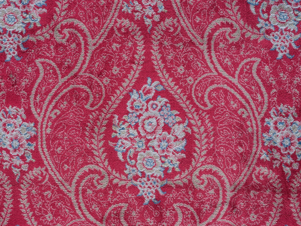 a close up of a red and blue paisley print fabric