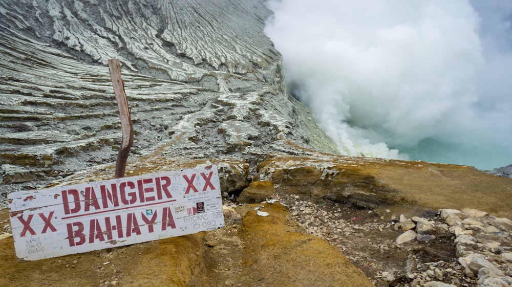 a sign that is on the side of a cliff