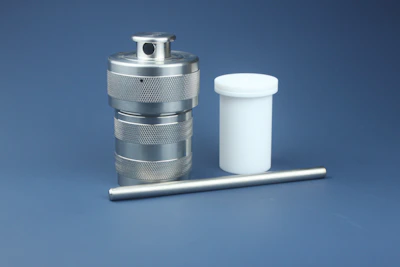 Stainless steel E-type retaining ring installed on a shaft in an industrial setting.