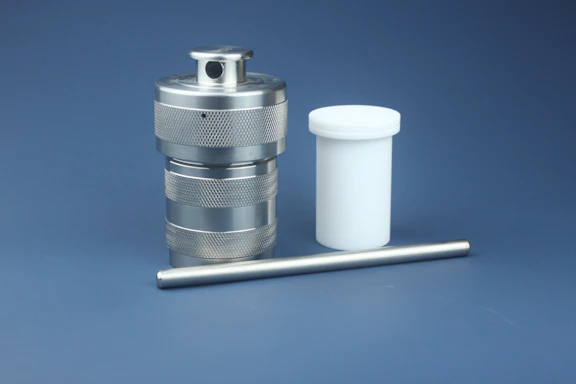 Stainless steel E-type retaining ring installed on a shaft in an industrial setting.