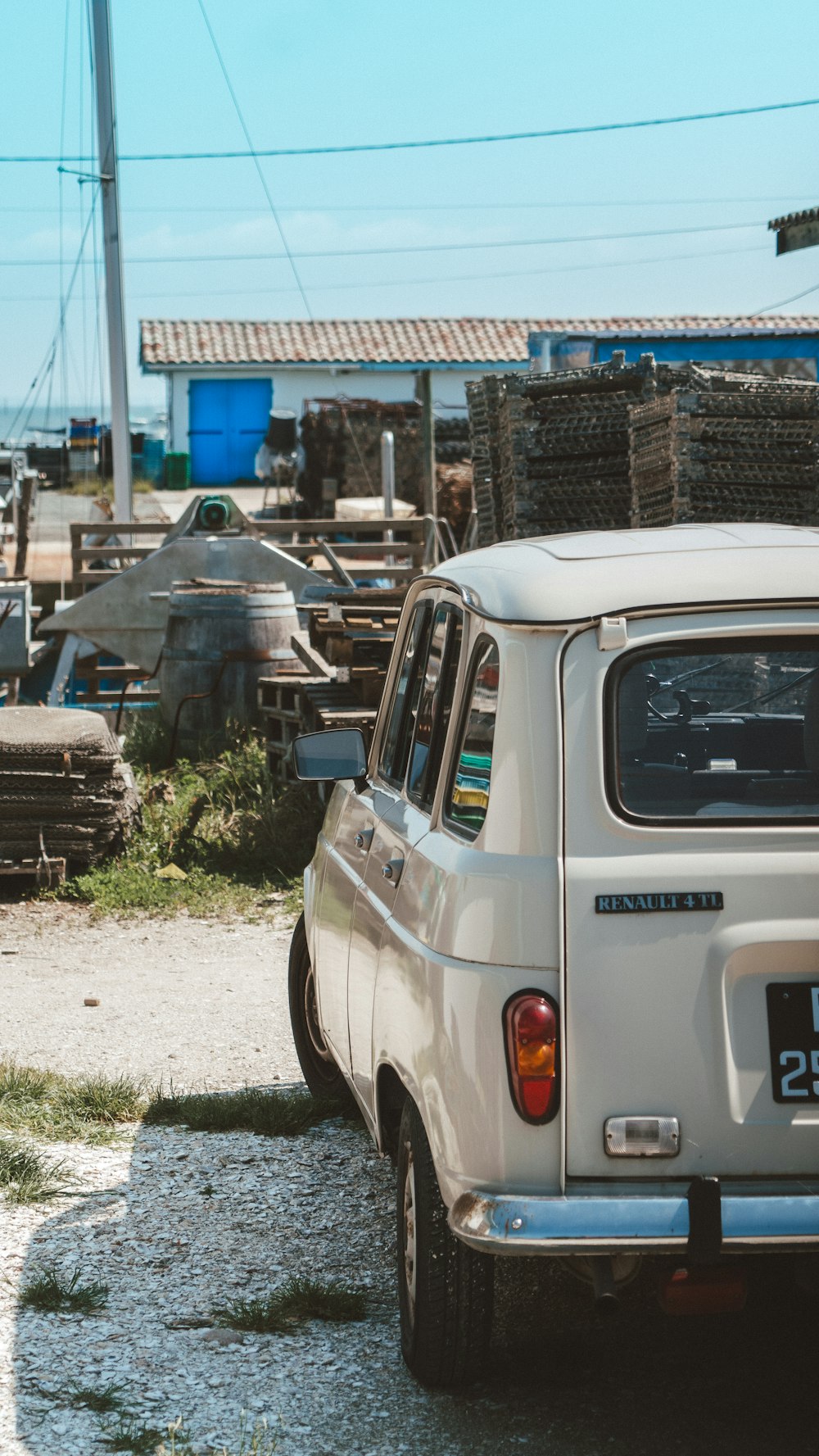 a white car parked next to a pile of tires