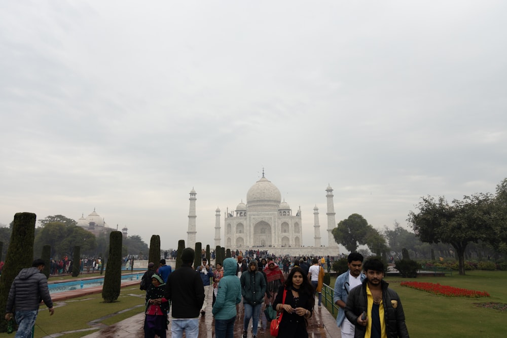 a group of people walking in front of a building