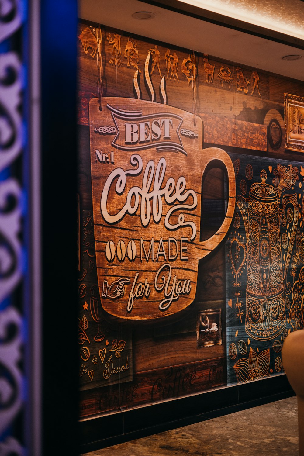 a coffee shop with a large wooden sign on the wall