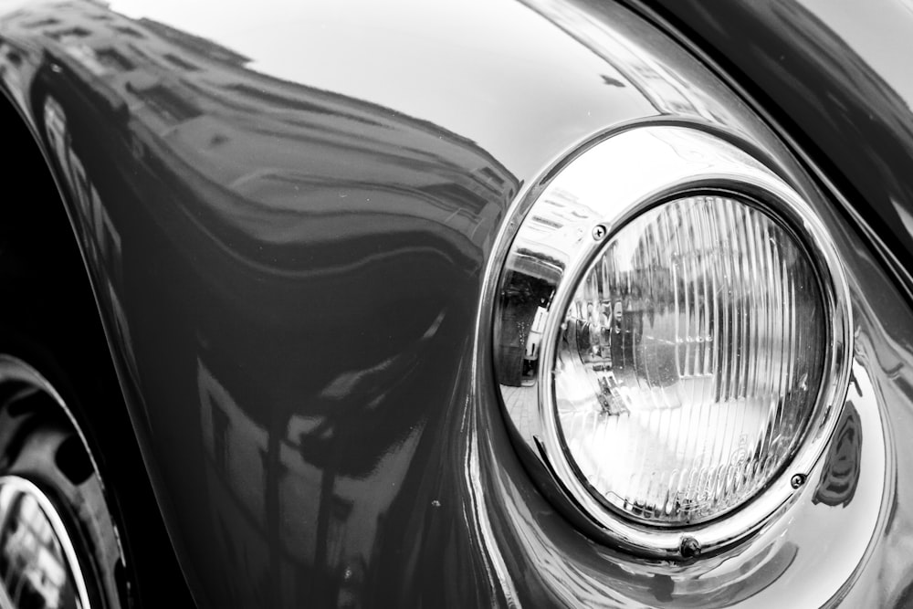 a black and white photo of a car's headlight