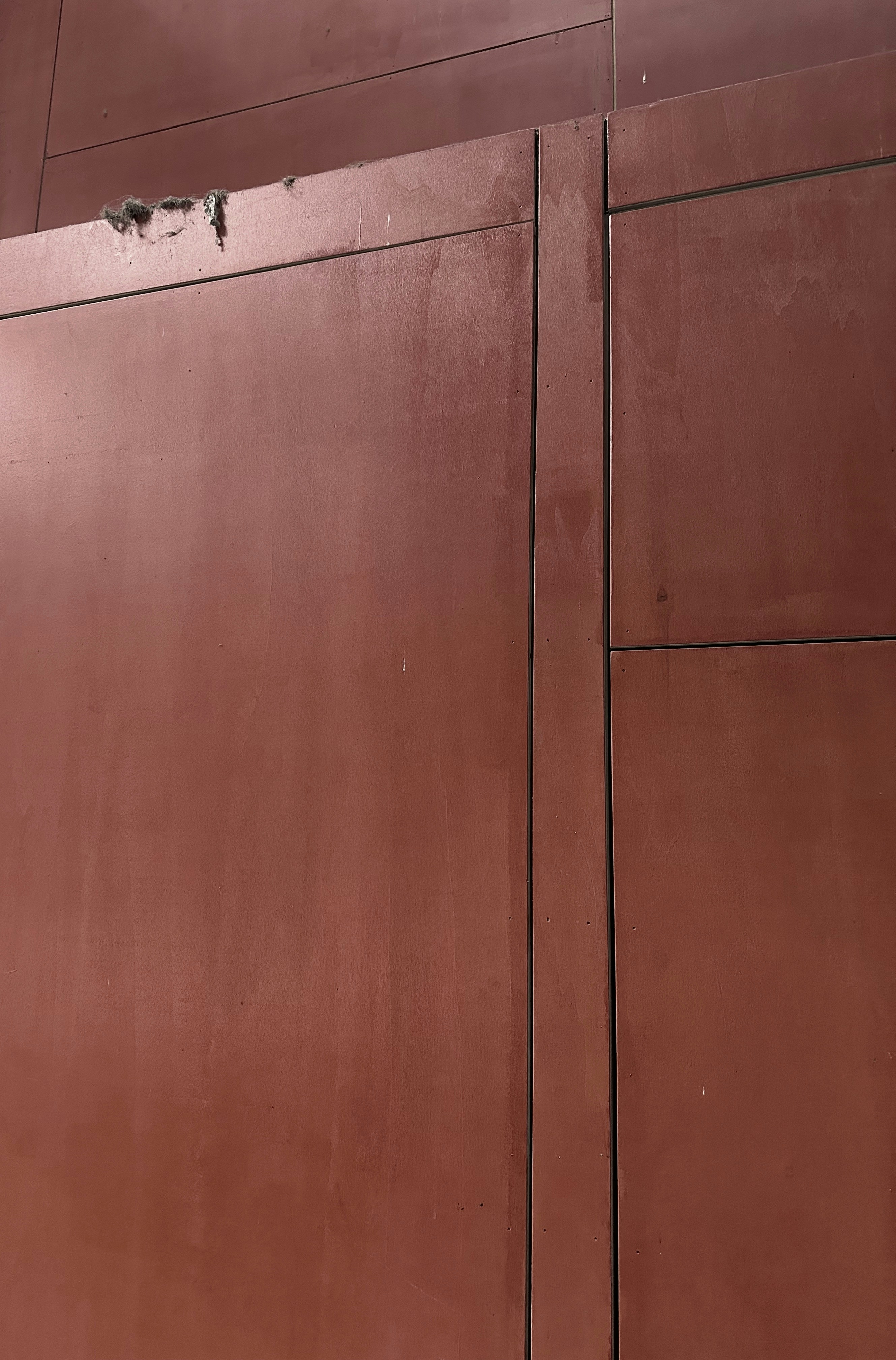 a red building with a clock on the side of it