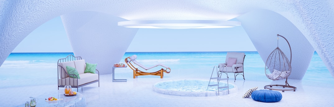 a room with a pool, chairs, and a hammock on the private beach