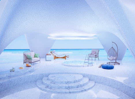 a room with a pool, chairs, and a hammock on the private beach