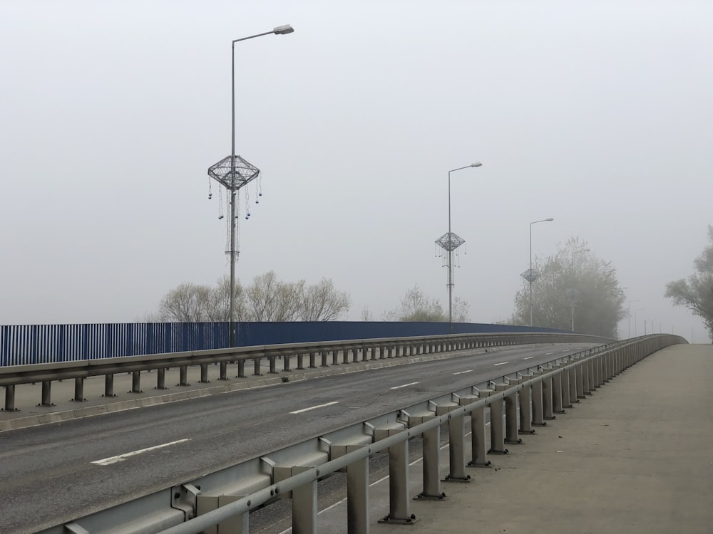 a foggy day on a highway with street lights