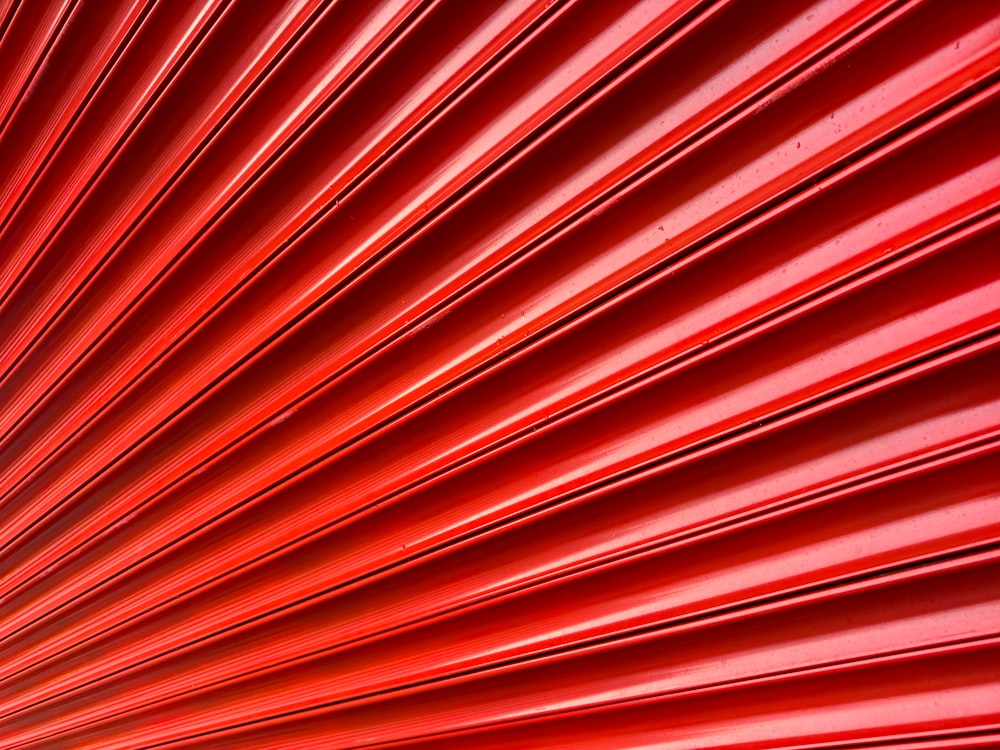 a close up of a red wall with lines