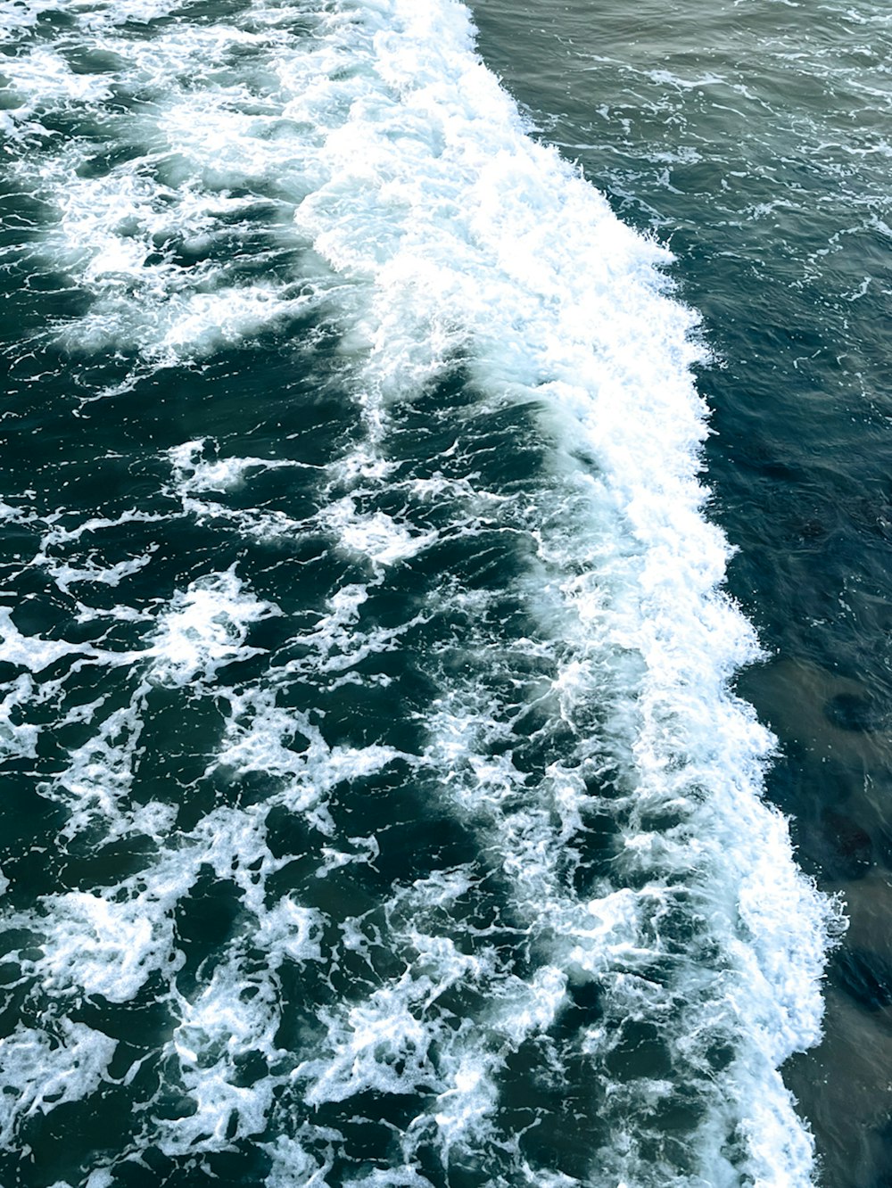 a man riding a surfboard on top of a wave in the ocean