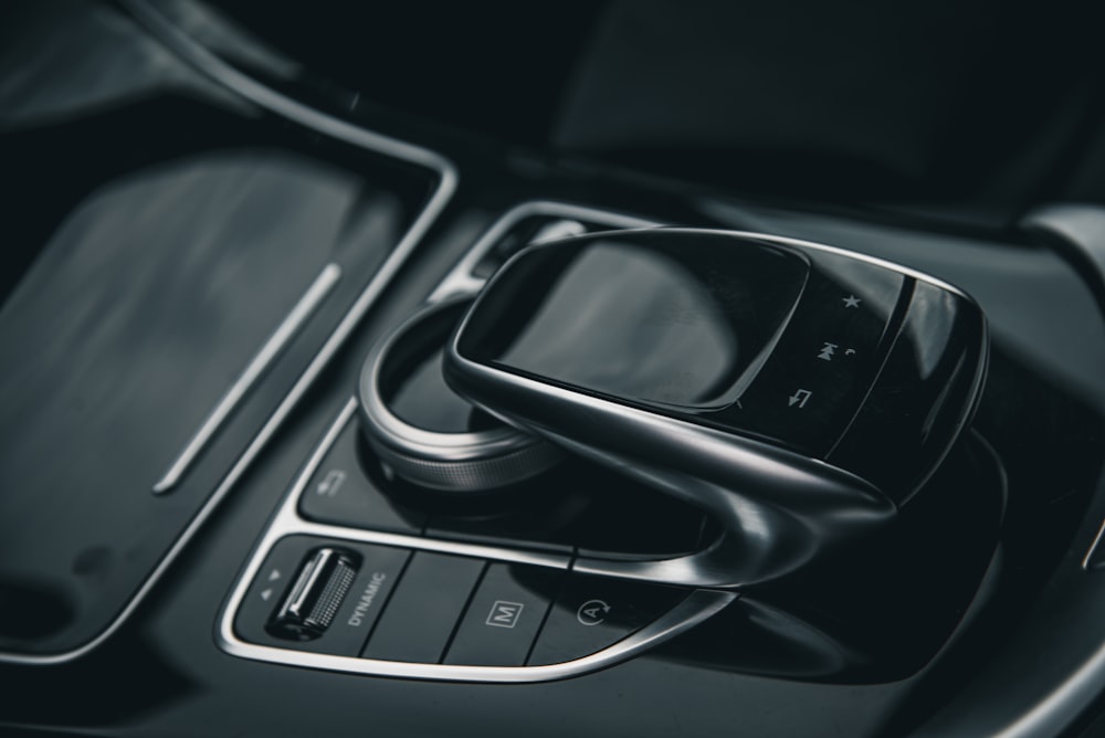 a car dashboard with a cell phone in the center console