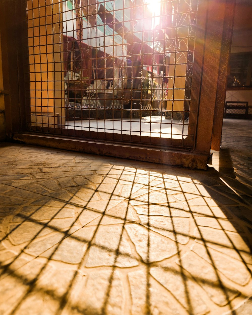 the sun shines through a window on a tiled floor