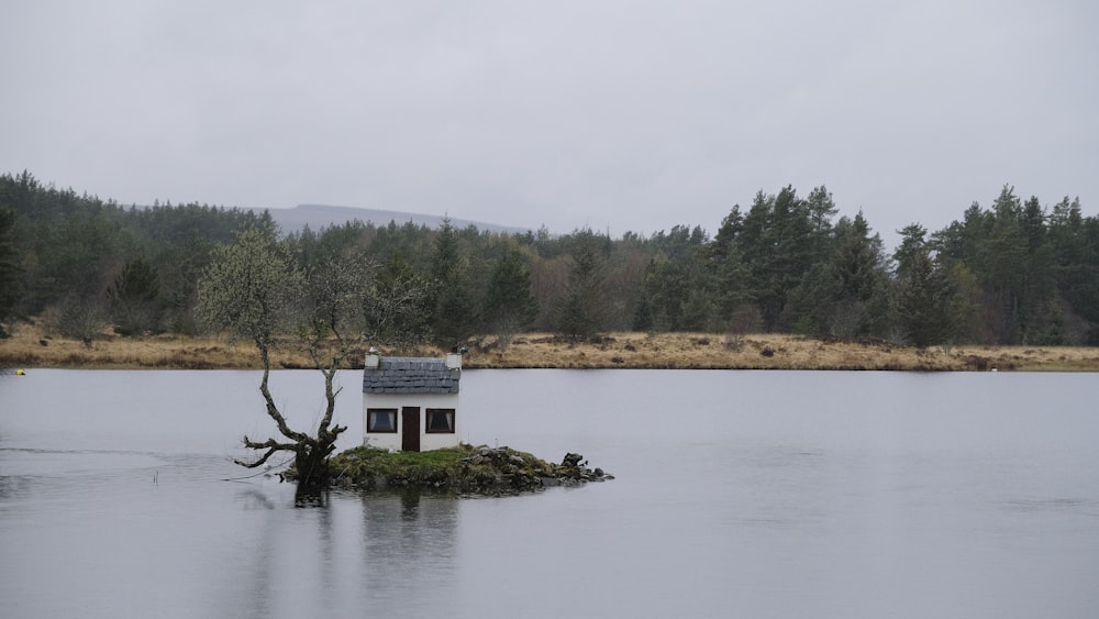 a small house on a small island in the middle of a lake
