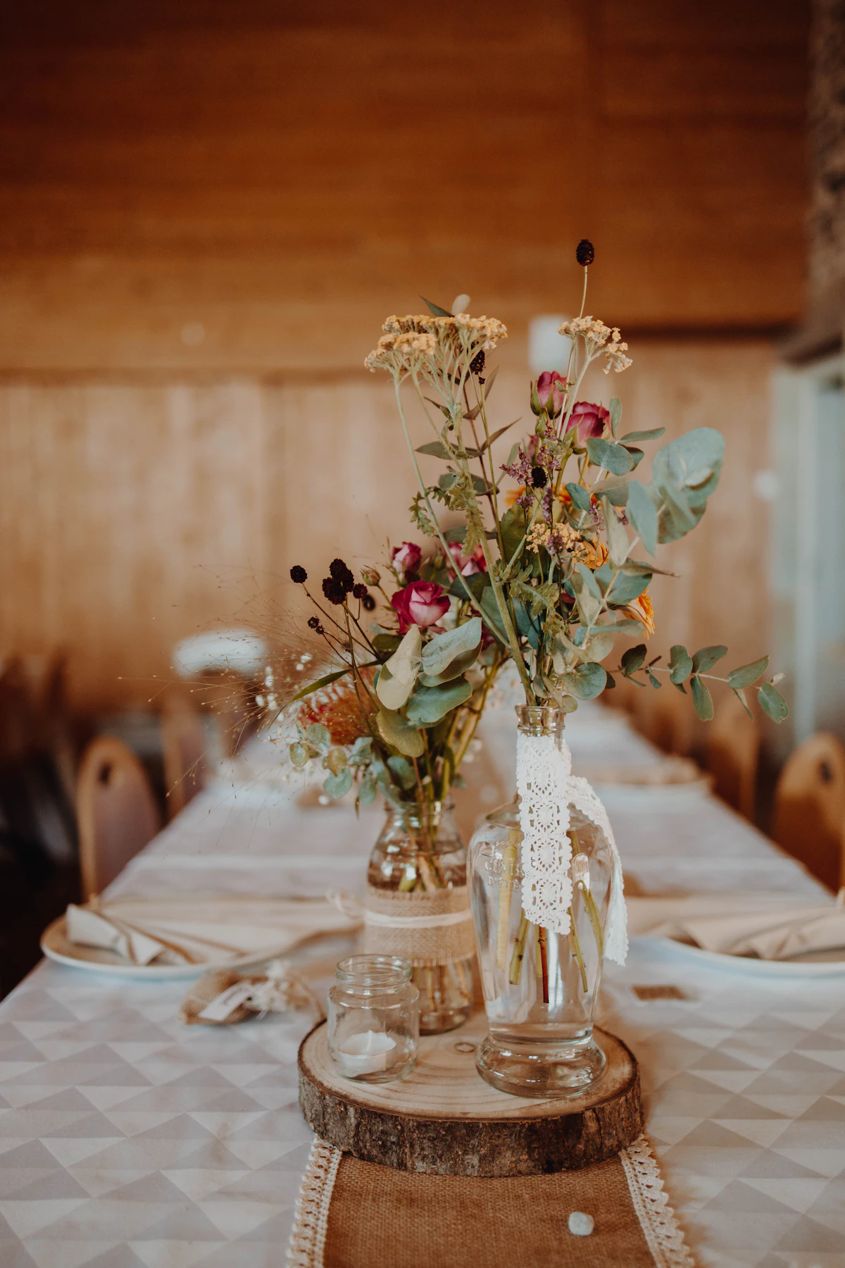 Wildflower posies along a rustic wedding table