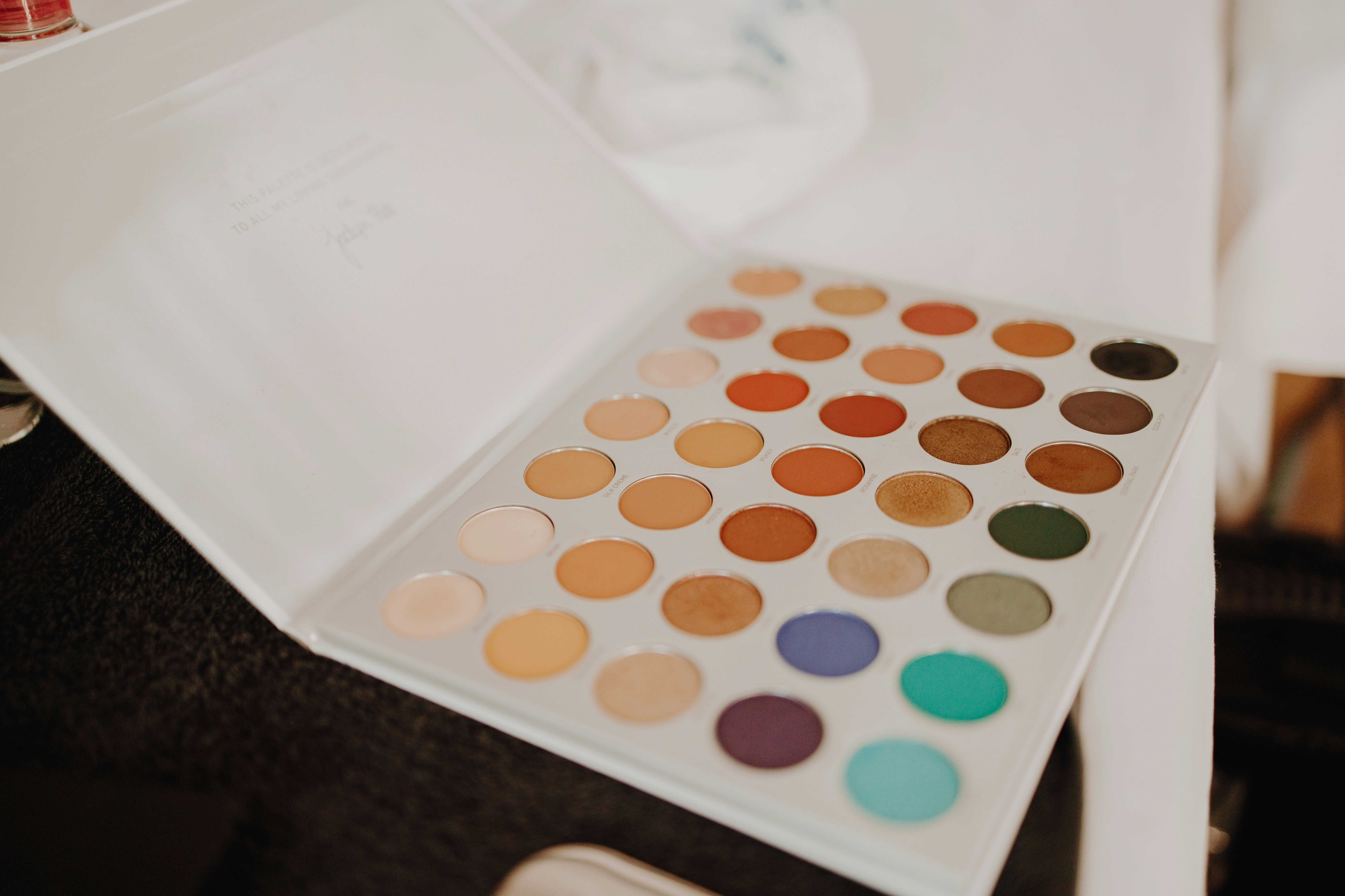 a close up of a palette of makeup on a table