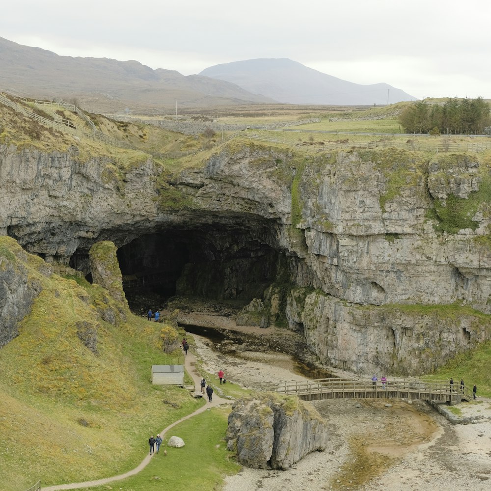 a group of people walking into a cave