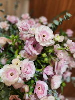 An elegant semi-custom hamper featuring soft pink tones and fresh green foliage details in a modern arrangement