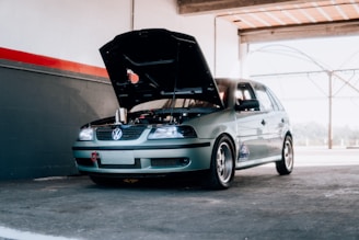 a car with its hood open in a garage