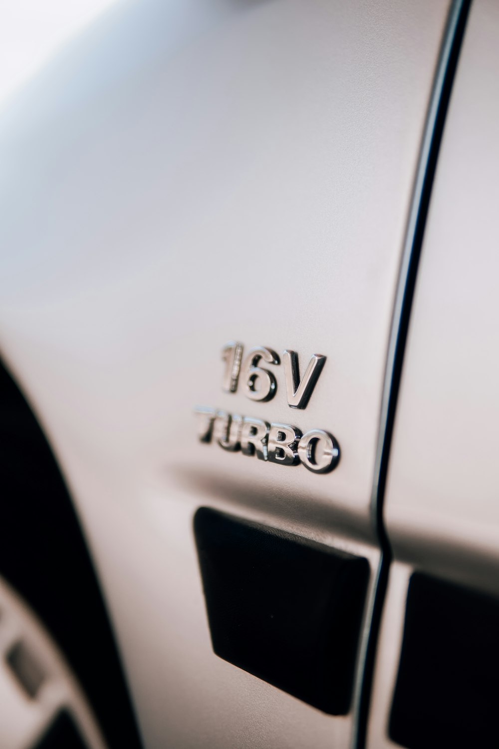 a close up of the emblem on a white car