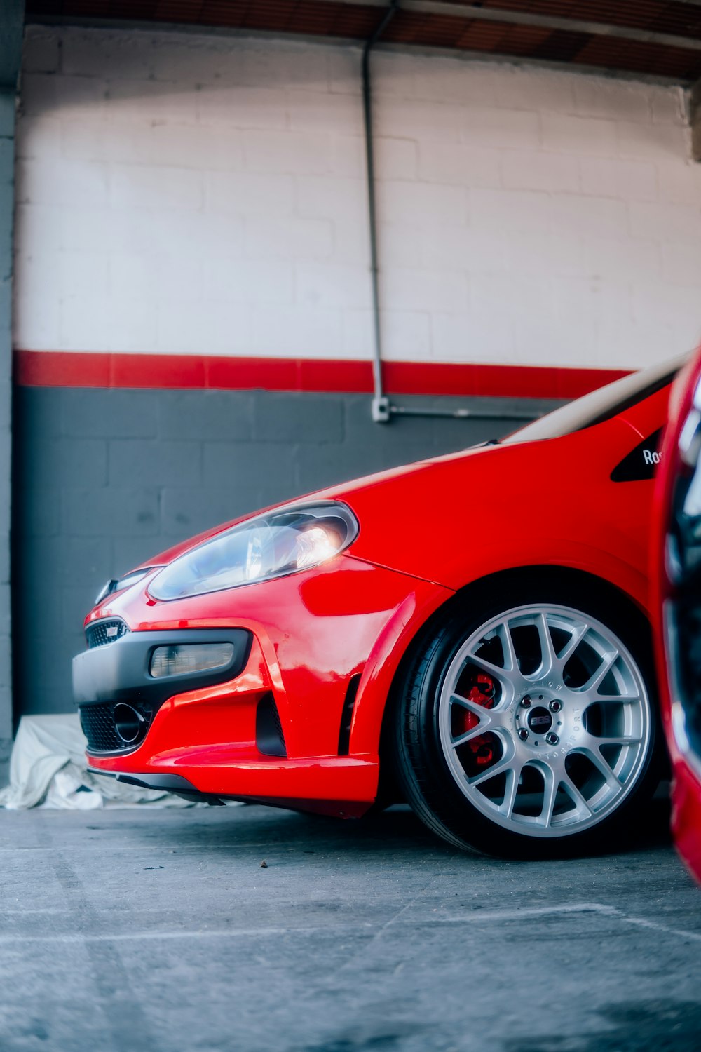 a red sports car parked in a garage