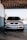 A silver Volkswagen car is parked inside a shaded garage area. The front view highlights the vehicle's headlights, grille, and license plate.