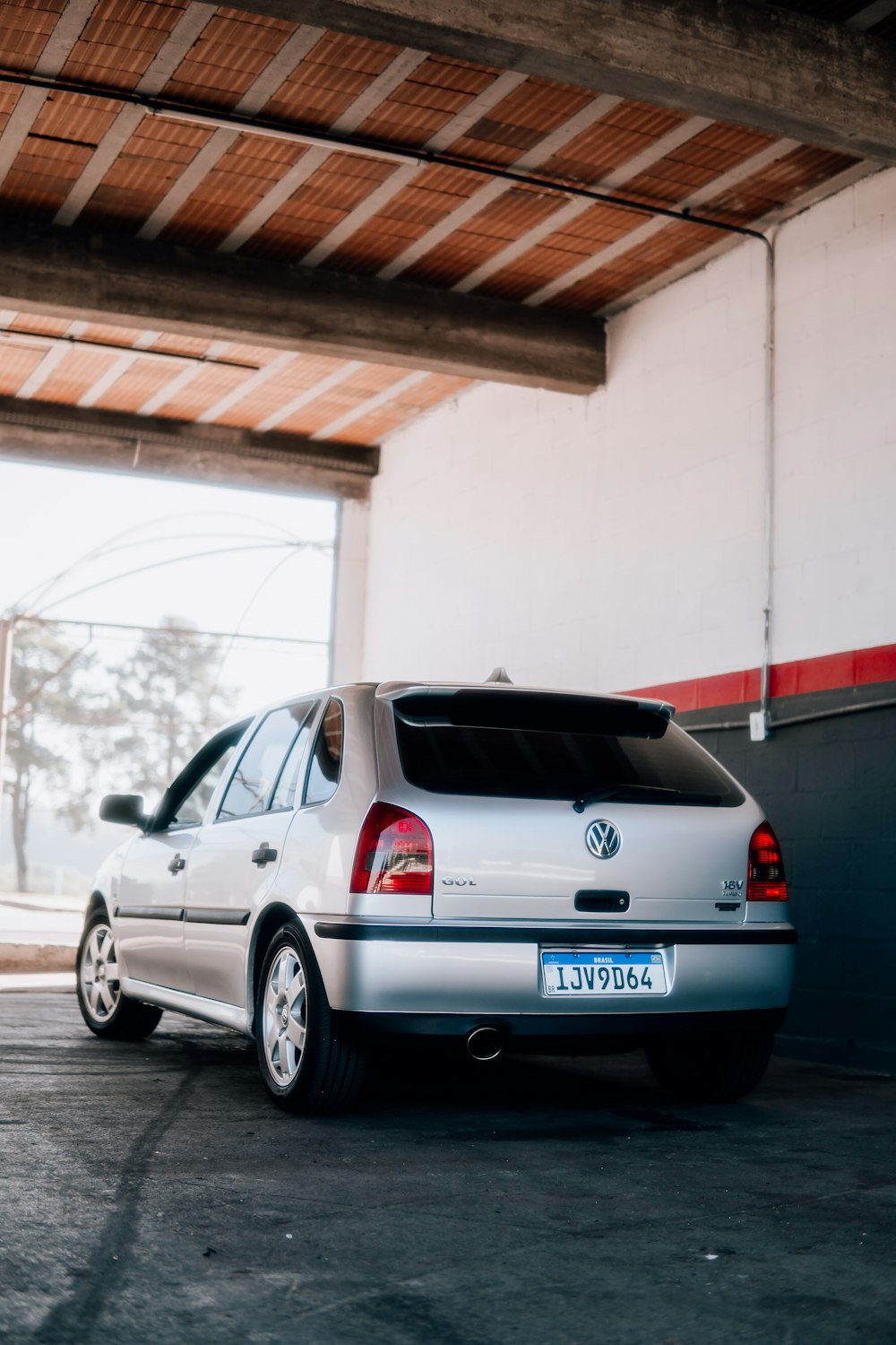 a silver car is parked in a garage