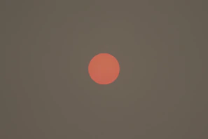 A close-up of a glowing burnt-orange coupon badge against a dark background