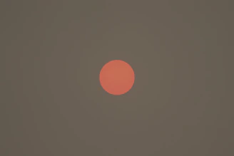 A close-up of a glowing burnt-orange coupon badge against a dark background