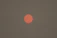 the sun is setting on a hazy day