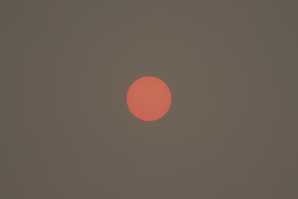 the sun is setting on a hazy day