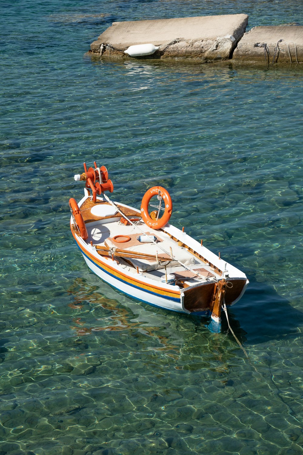 a small boat floating on top of a body of water