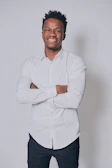 Casual portrait of an instructor smiling with arms crossed.