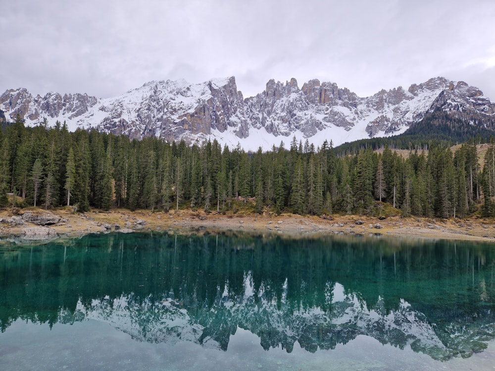 a mountain range is reflected in a lake
