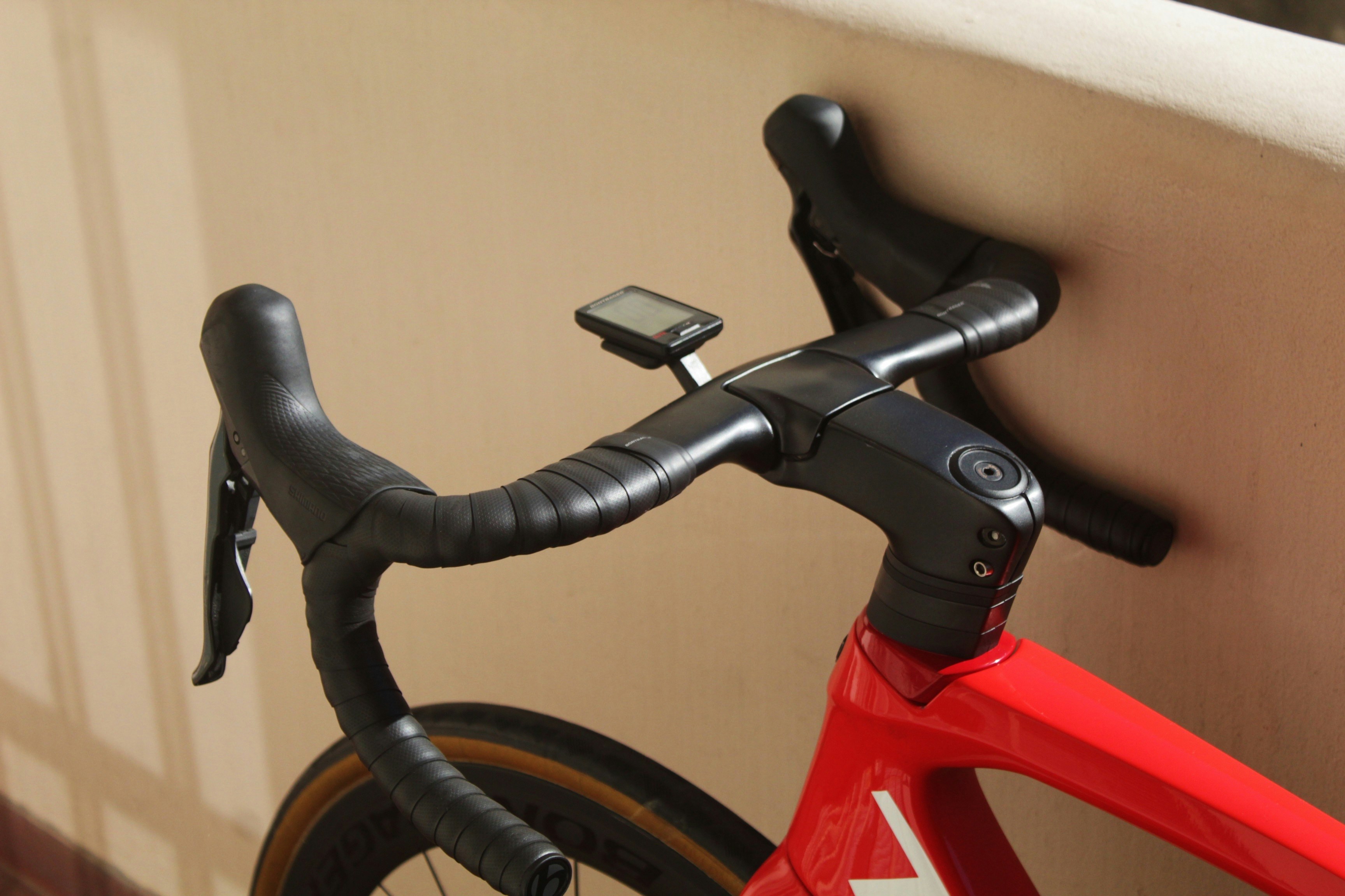 a close up of a bike with a phone on the handlebars