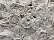 Housekeeper neatly arranging fresh towels in a hotel room.