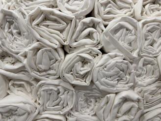 Close-up of folded interfold paper towels stacked neatly on a clean white surface