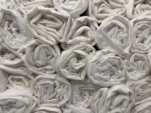 A collection of fluffy towels stacked in a bathroom setting.