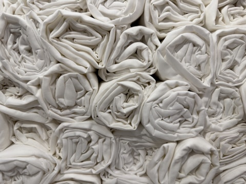 A close-up of absorbent cotton rolls stacked neatly.