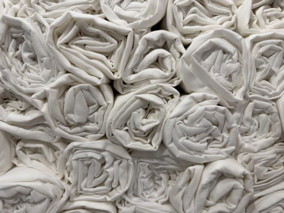A stack of neatly folded commercial hand towels in a bright, clean setting.