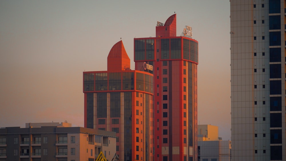a tall red building with a clock on the top of it