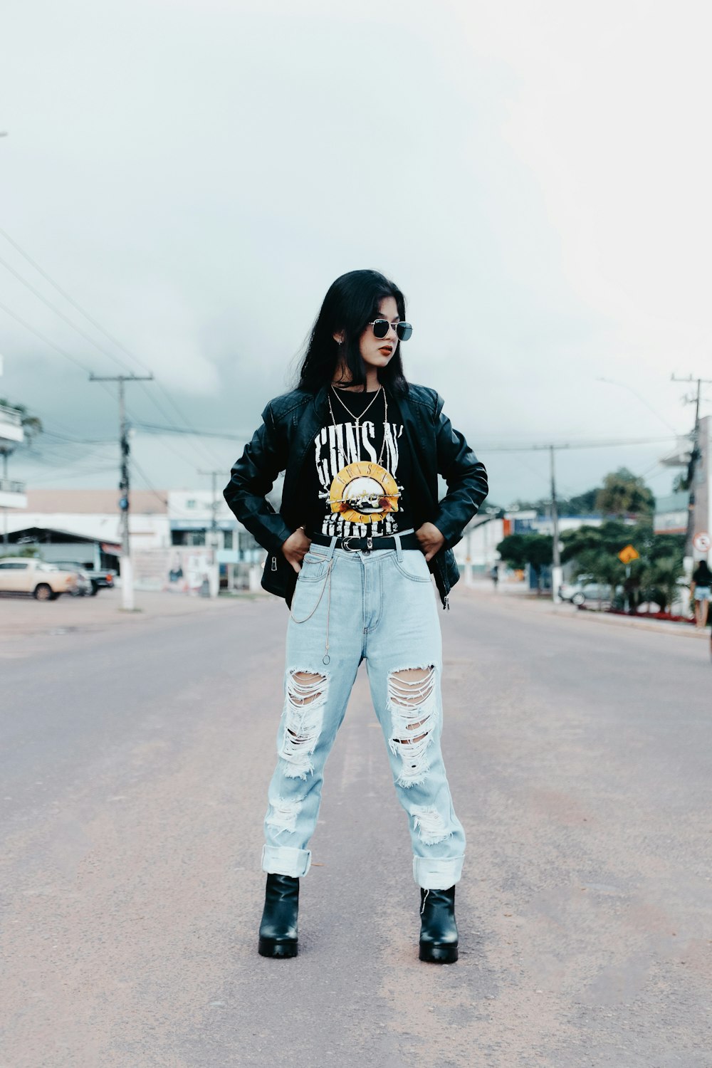 a woman standing in the middle of a street